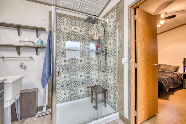 bathroom with ceiling fan, walk in shower, and vanity