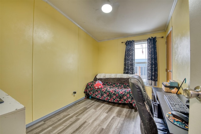 bedroom with light hardwood / wood-style floors and crown molding