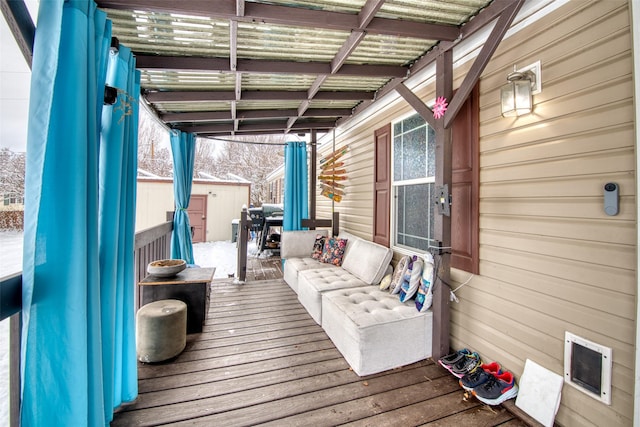 wooden terrace featuring a storage shed and an outdoor hangout area