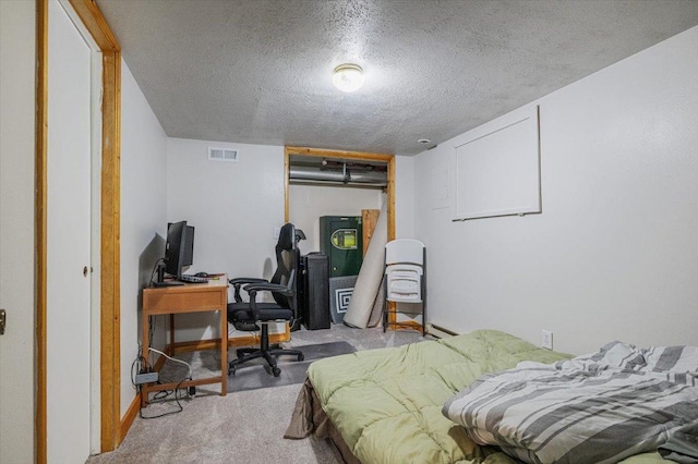 bedroom with light colored carpet, a textured ceiling, and a closet