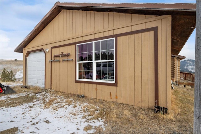 view of snow covered exterior featuring an outbuilding