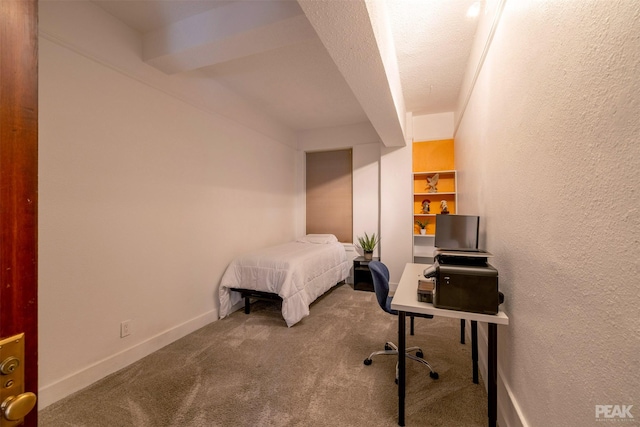 bedroom with a textured ceiling and carpet