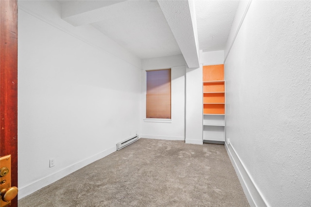 unfurnished room with baseboard heating, light carpet, and a textured ceiling