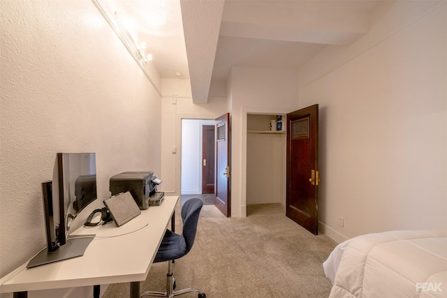 home office with beam ceiling and light colored carpet