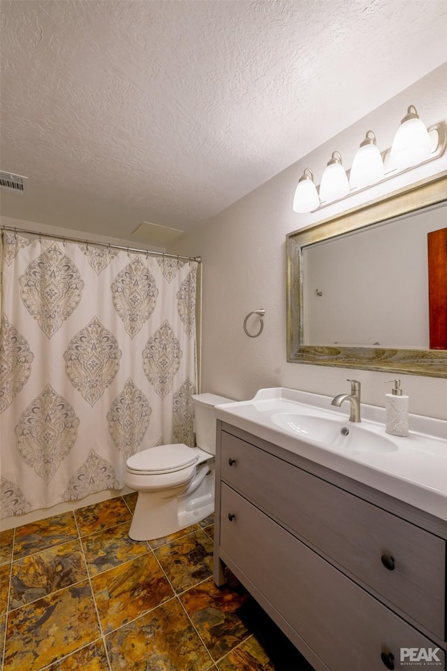 full bathroom with vanity, shower / bath combination with curtain, a textured ceiling, and toilet