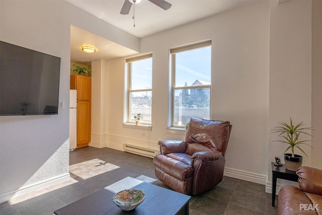 living room with baseboard heating and ceiling fan