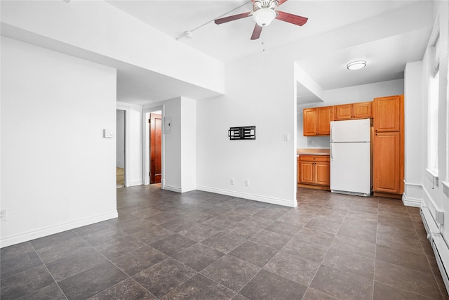 kitchen featuring a textured ceiling, ceiling fan, a baseboard radiator, and white appliances