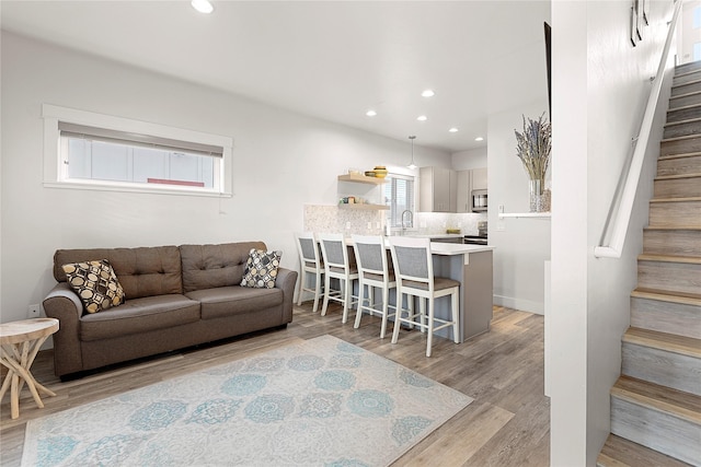 living room featuring plenty of natural light and light hardwood / wood-style flooring