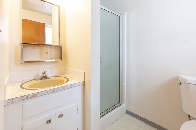 bathroom featuring vanity, backsplash, toilet, and walk in shower