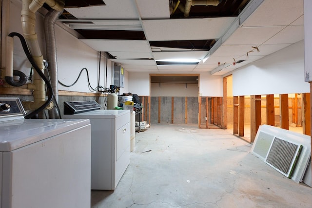 basement featuring a paneled ceiling and independent washer and dryer