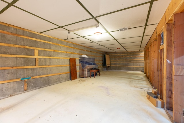 basement with a paneled ceiling