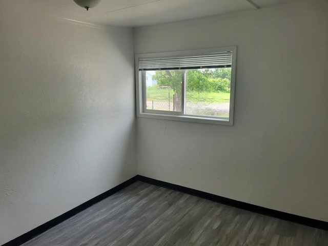 spare room featuring dark hardwood / wood-style floors