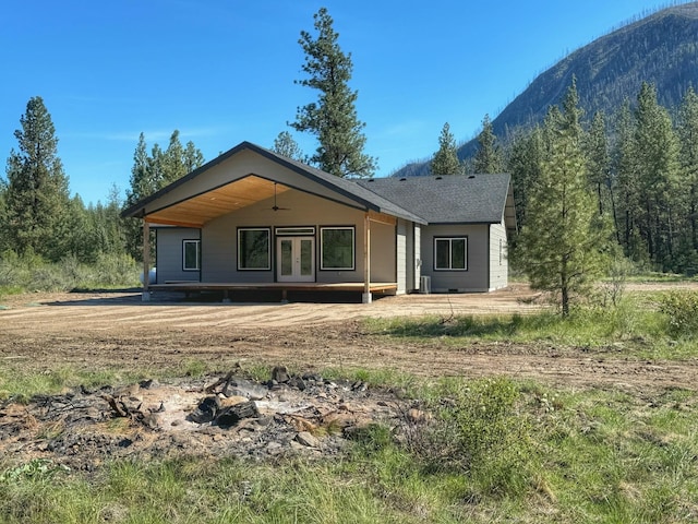 back of house featuring a mountain view, french doors, and ceiling fan