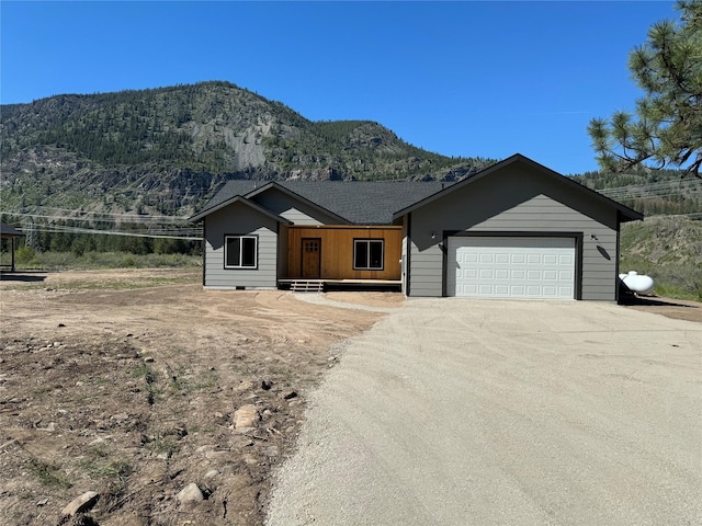 ranch-style home with a mountain view and a garage