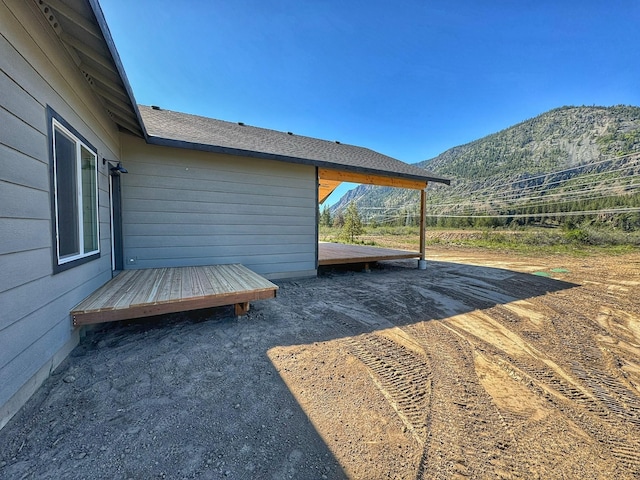 view of yard featuring a deck with mountain view