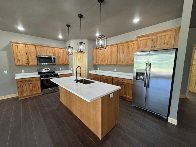 kitchen featuring sink, dark wood-type flooring, stainless steel appliances, an island with sink, and decorative light fixtures