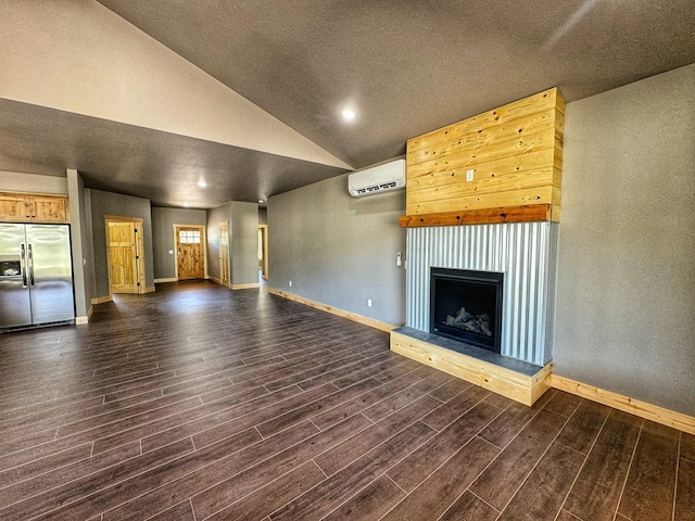 unfurnished living room with vaulted ceiling and a wall mounted AC