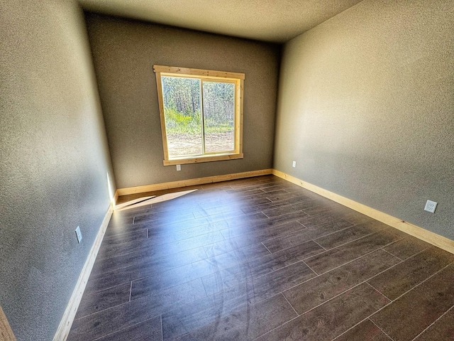 spare room featuring dark hardwood / wood-style floors