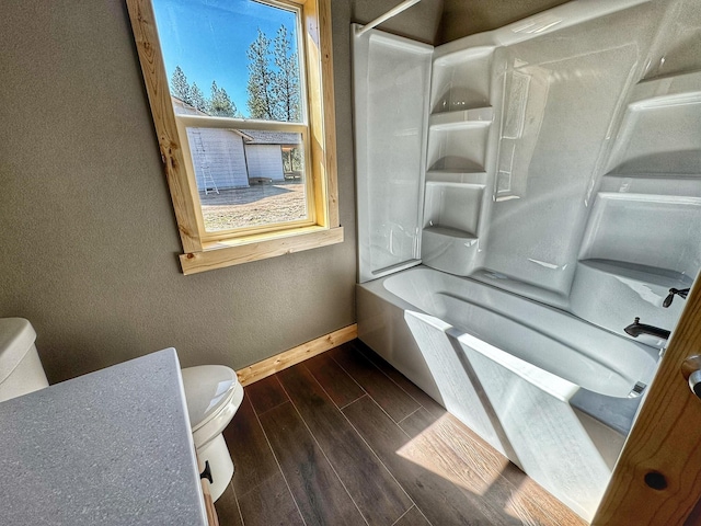 bathroom featuring shower / bathtub combination and toilet