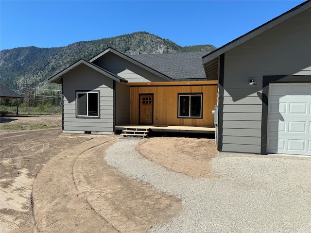 single story home featuring a mountain view and a garage