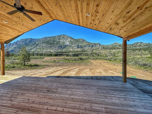 wooden terrace with a mountain view and ceiling fan