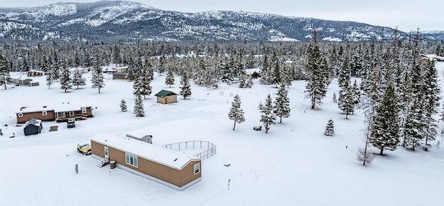 snowy aerial view with a mountain view