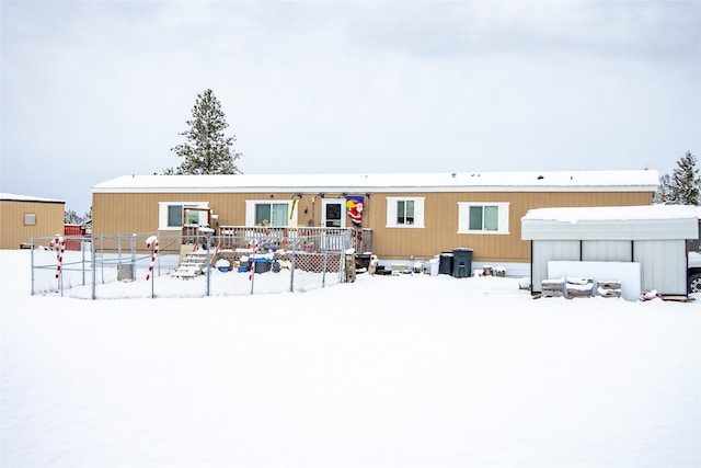 view of snow covered back of property