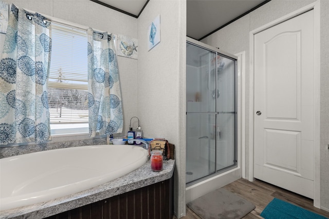 bathroom with hardwood / wood-style floors, separate shower and tub, and crown molding