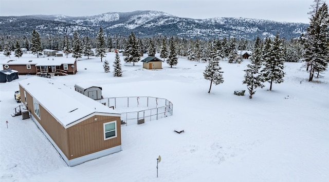 snowy aerial view with a mountain view