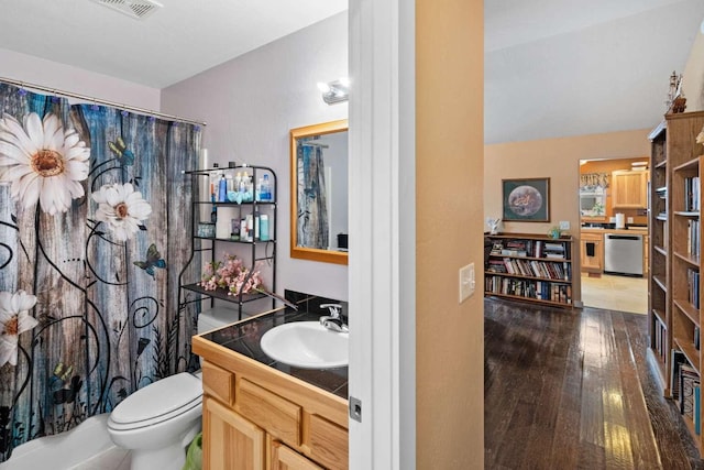 full bathroom featuring shower / bathtub combination with curtain, hardwood / wood-style floors, vanity, and toilet