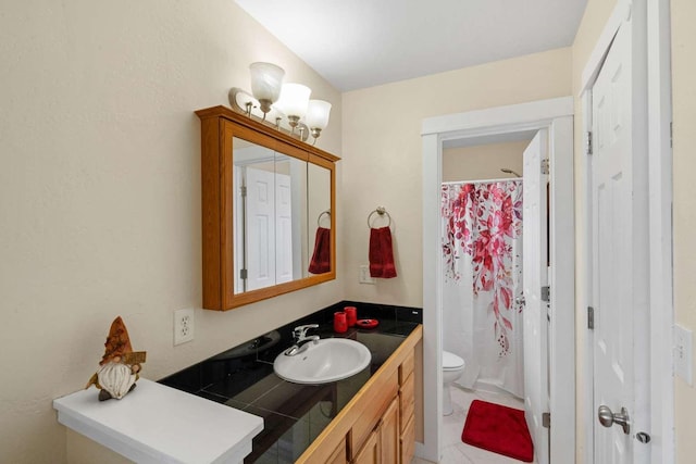 bathroom featuring vanity, toilet, and curtained shower