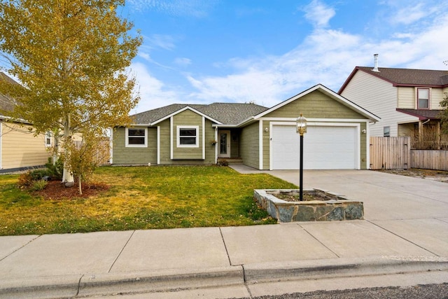 view of front of home featuring a front yard and a garage