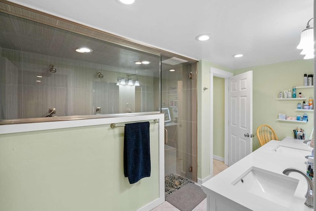 bathroom with tile patterned flooring, vanity, and walk in shower