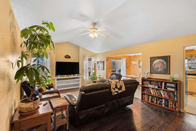 living room with ceiling fan, dark hardwood / wood-style flooring, and vaulted ceiling