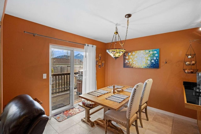 dining area featuring light tile patterned flooring