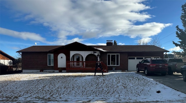 ranch-style home with covered porch and a garage