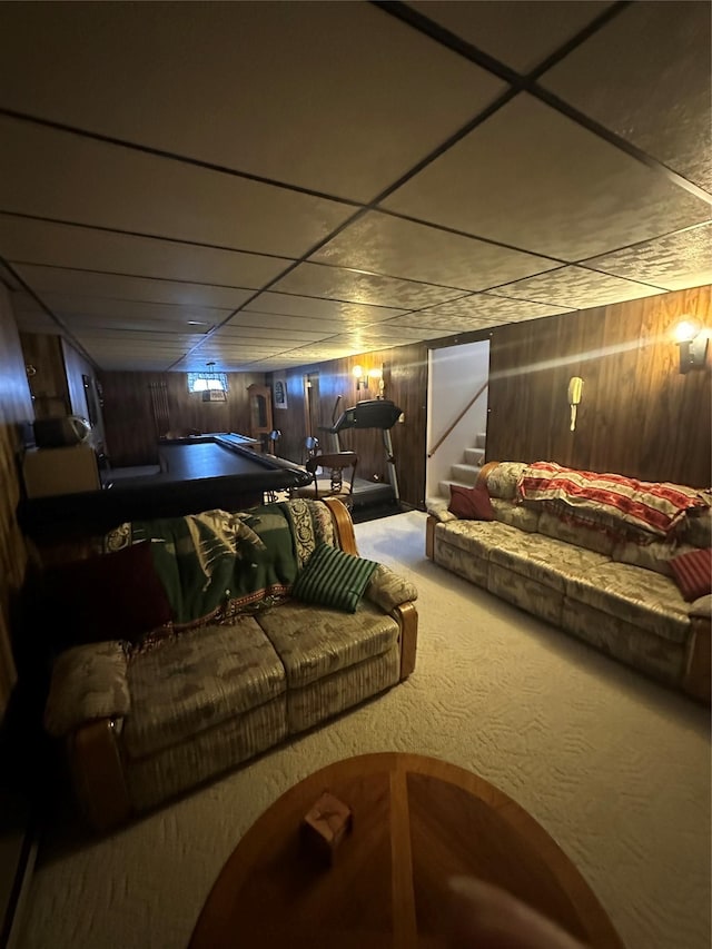 home theater room with carpet flooring and wooden walls