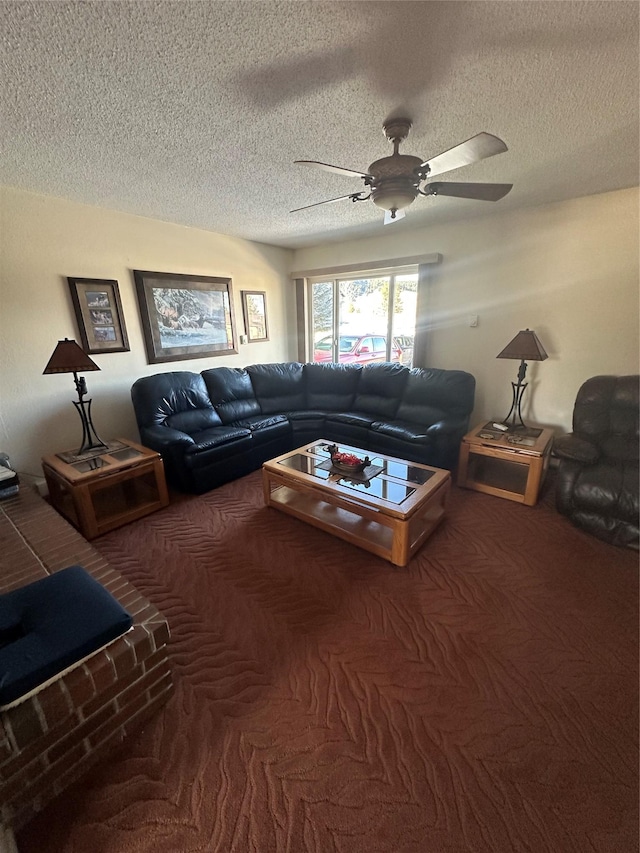 living room with ceiling fan, carpet floors, and a textured ceiling