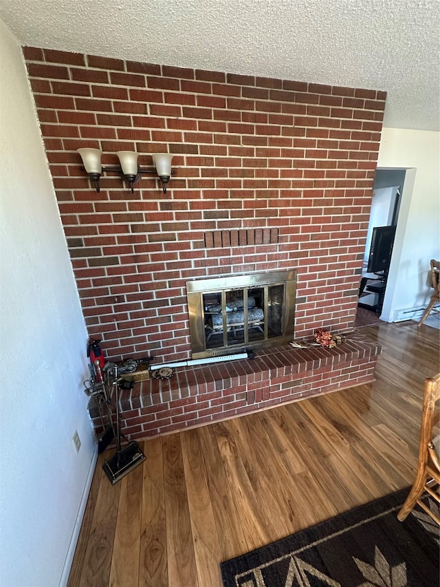 interior details with hardwood / wood-style flooring, a fireplace, and a textured ceiling