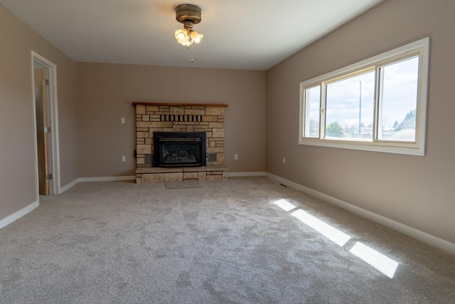 unfurnished living room with baseboards, carpet flooring, and a fireplace