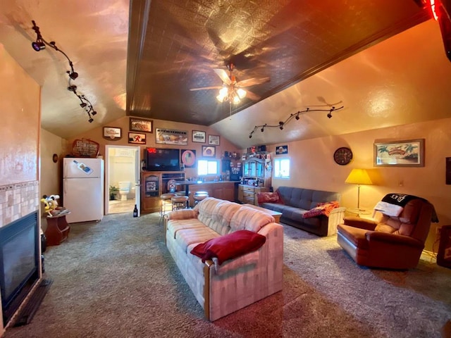 cinema featuring lofted ceiling, ceiling fan, carpet floors, and rail lighting