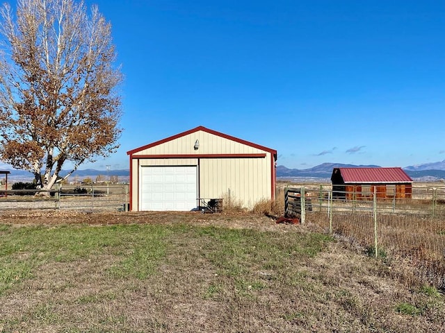 garage with a mountain view and a rural view