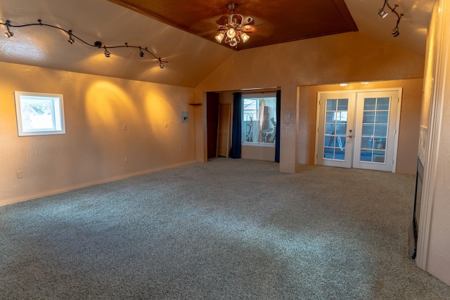spare room featuring track lighting, vaulted ceiling, carpet, and french doors