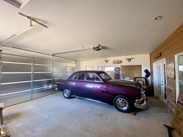 garage with a garage door opener and french doors