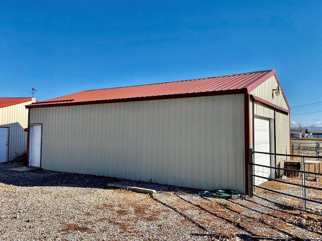 view of outdoor structure with fence, an outbuilding, and central air condition unit