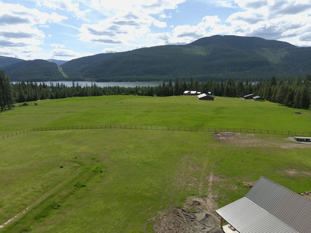 property view of mountains featuring a water view and a rural view