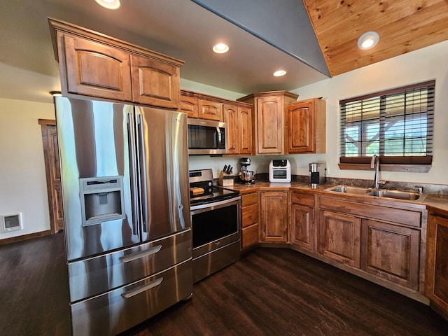 kitchen with wood ceiling, stainless steel appliances, vaulted ceiling, sink, and dark hardwood / wood-style floors