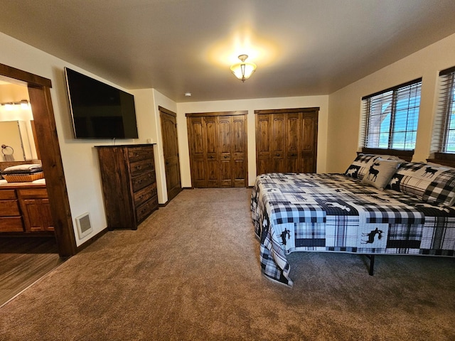 carpeted bedroom with multiple closets