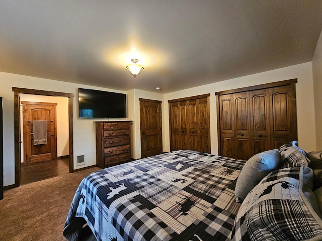 carpeted bedroom featuring two closets