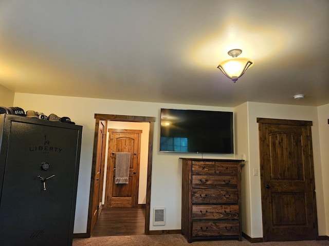 bedroom with dark colored carpet